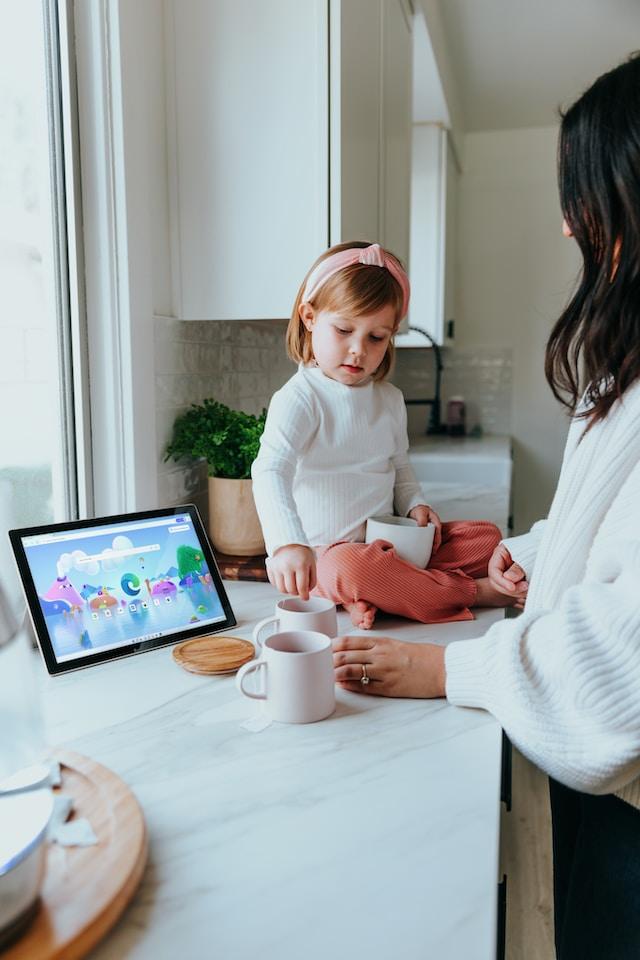 Picture of woman with child on countertop with Surface Pro laptop